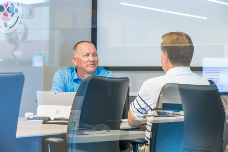 Two associates collaborating at a desk