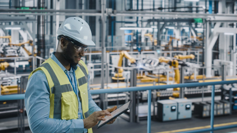 Man working on a manufacturing facility automation audit to improve efficiency