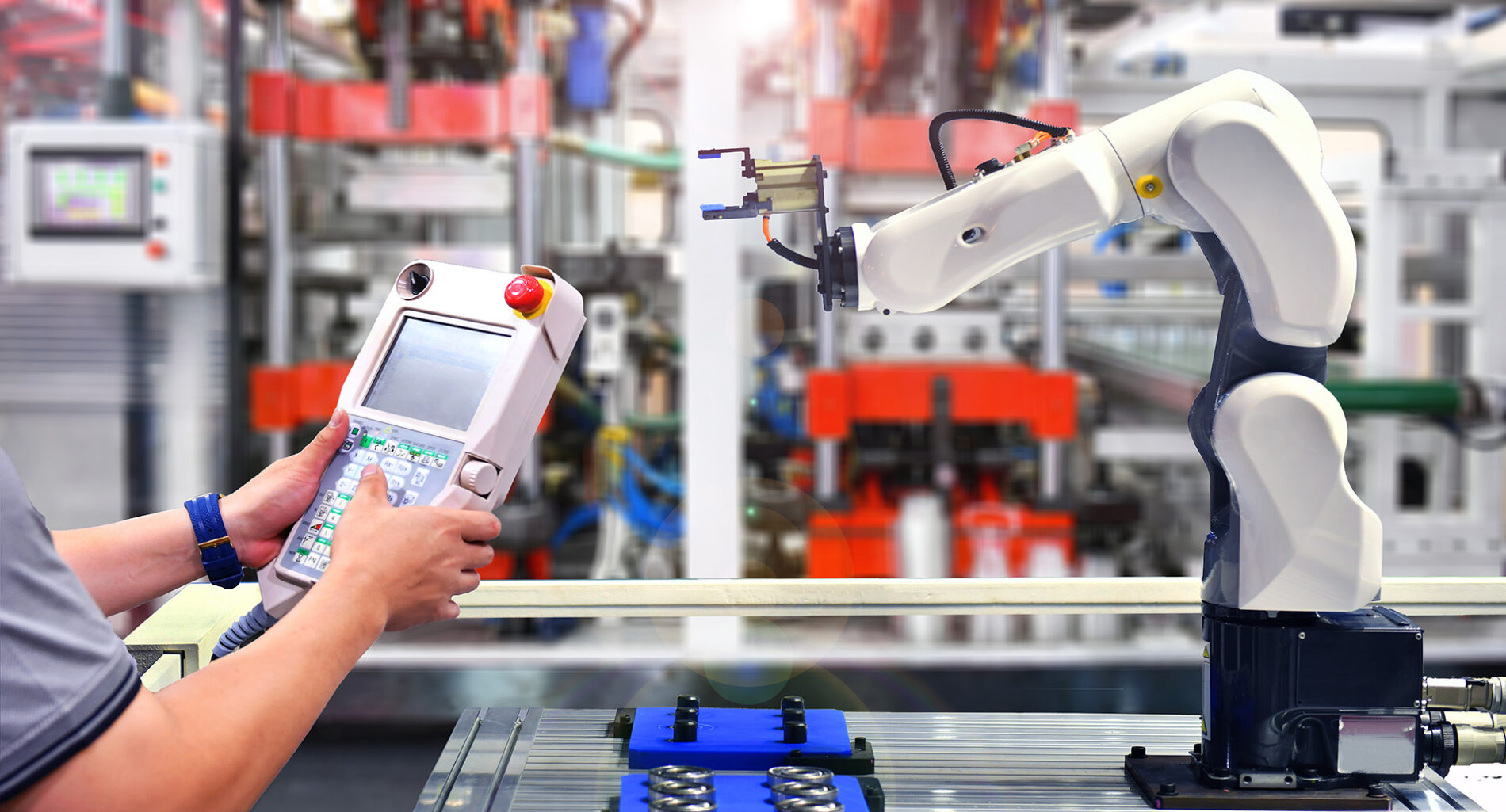 Engineer check and control automation Robot arm machine for Aluminum cans food packing process in factory.