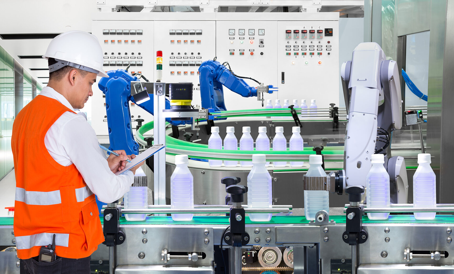 Engineer checking automated robotics in drinks production plant of factory
