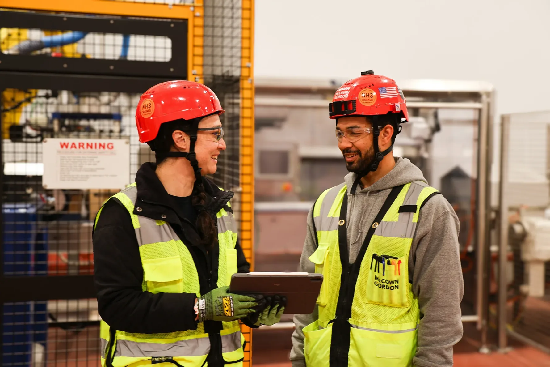mccowngordon associates laughing and smiling while collaborating inside a food manufacturing plant