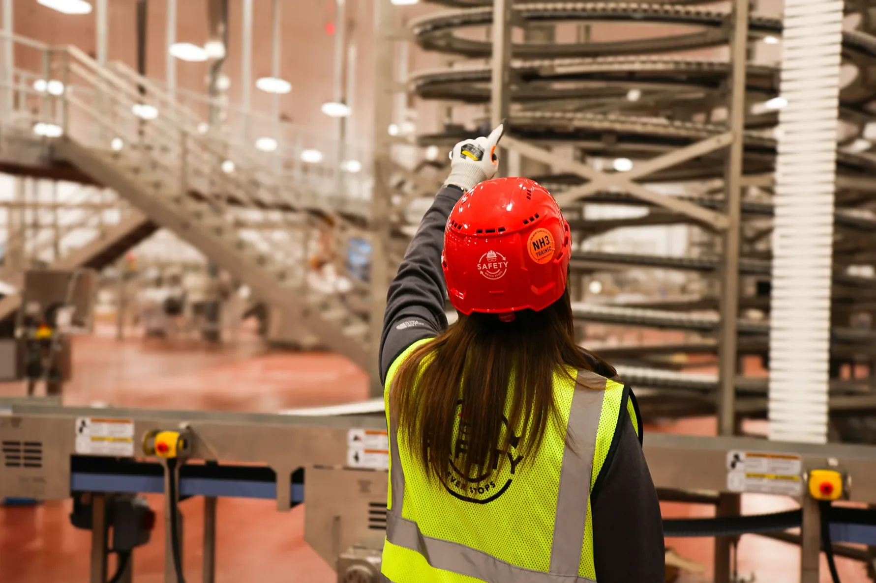 McCownGordon associate pointing at something inside a food manufacturing facility